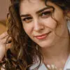 Close-up portrait of a woman with long curly brown hair