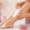 Woman applying a waxing strip to her lower leg
